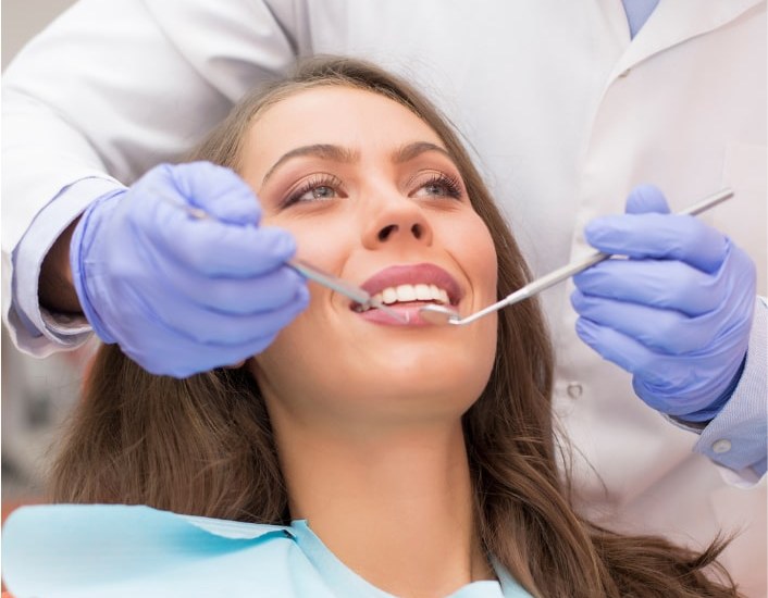 A dentist examining a patient during a consultation at Smile 4U Family Dental Clinic, Kurla